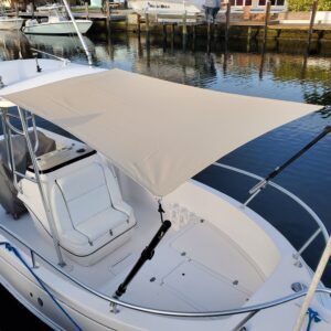 A white boat with a sail on top of it