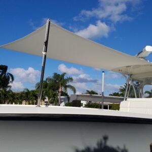 A white boat with a white sail on top of it.