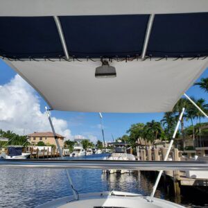 A boat with a blue canopy on top of it