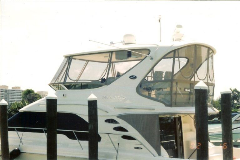 A large white boat is docked at a dock