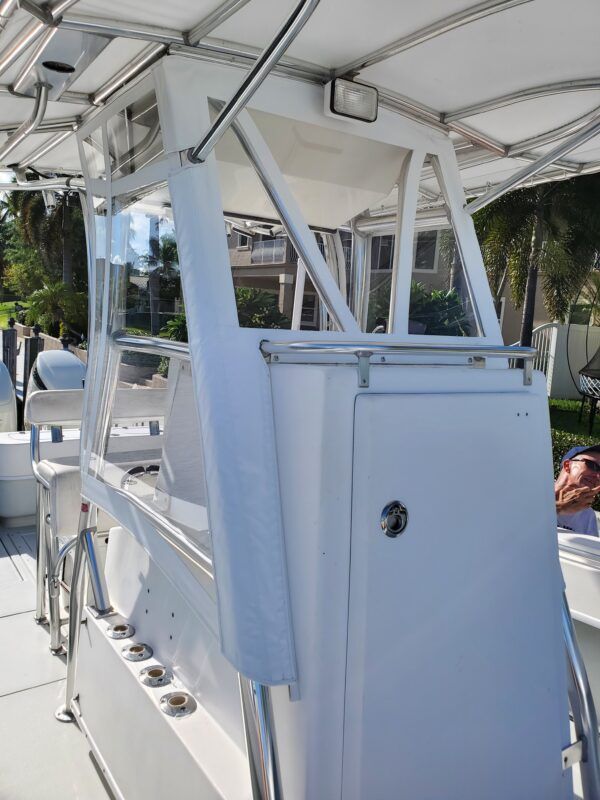 A white boat with a canopy on top of it