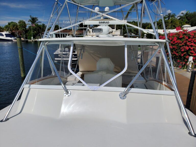 A boat is docked in a marina with a tower on top of it.