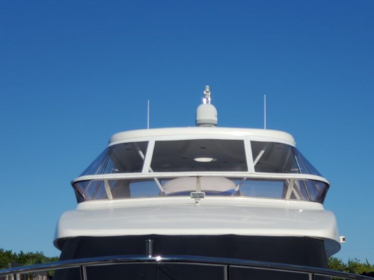 The front of a boat with a blue sky in the background