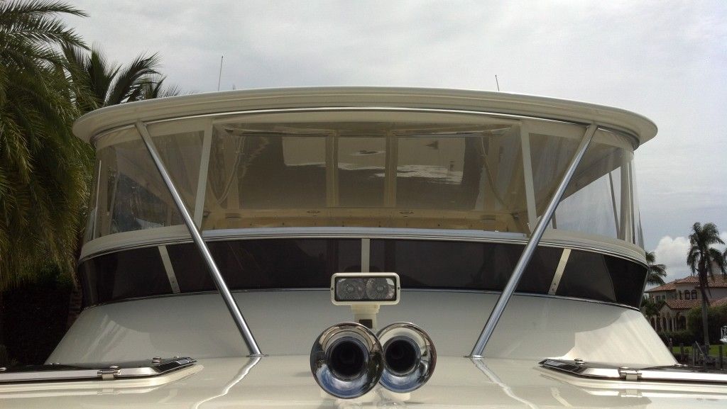 The front of a boat with a canopy and two exhaust pipes