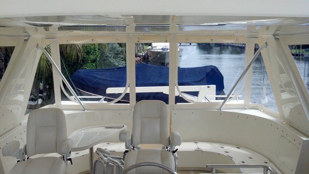The inside of a boat with a steering wheel and seats