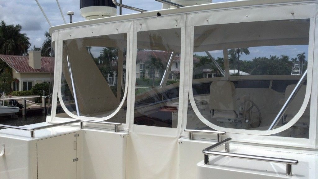A white boat with clear windows and a steering wheel.