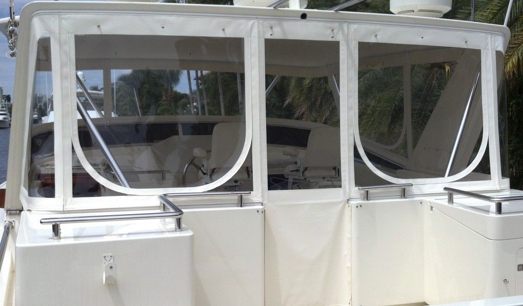 A white boat with a clear canopy on top of it