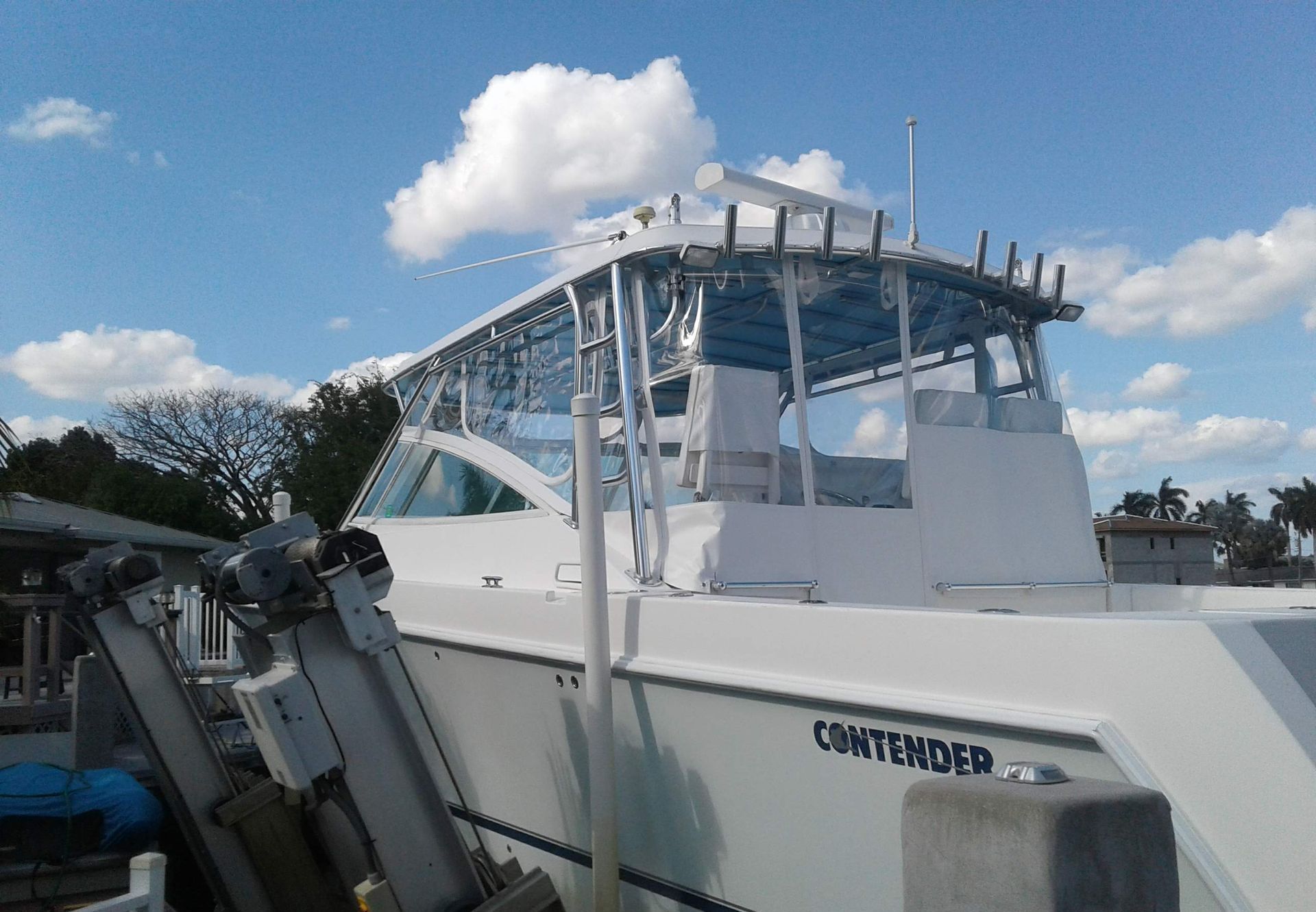 A white boat with a clear windshield and a blue trim
