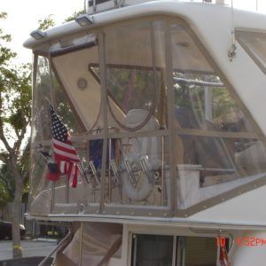 A white boat with an american flag on the deck