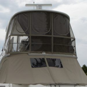 The front of a boat with a clear canopy and a radar on top