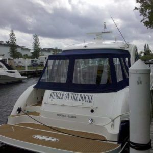 A white boat named stinger on the docks is docked at a dock