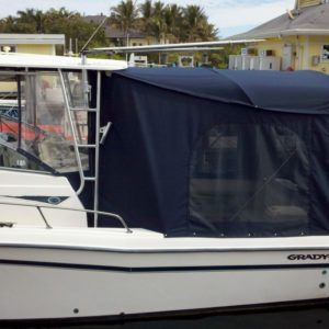 A white boat with a blue canopy on top of it
