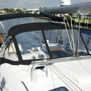 A white boat with a black canopy on top of it