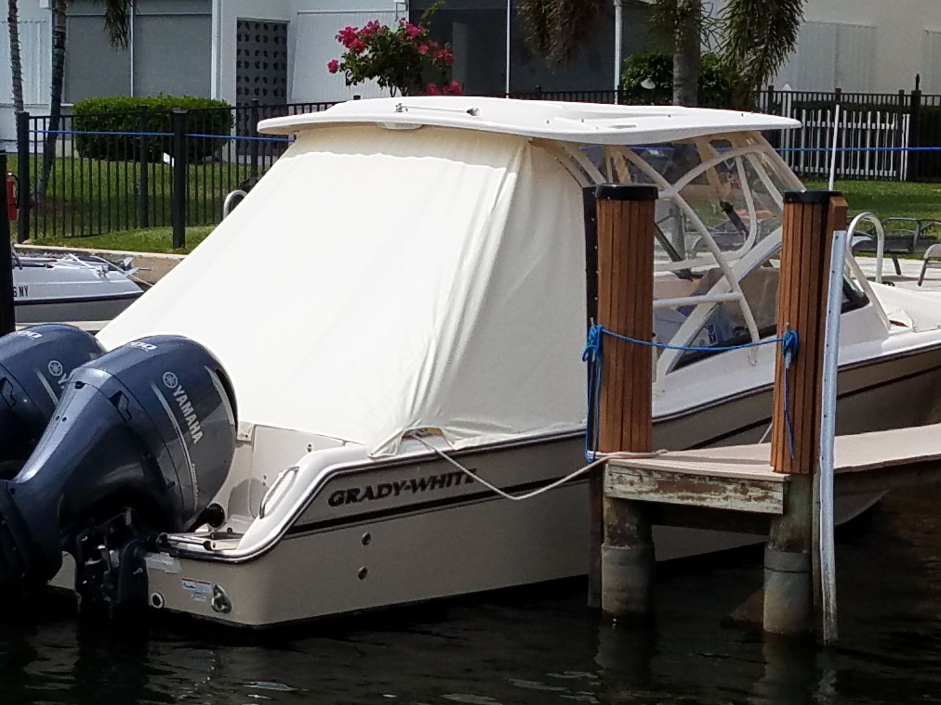 A boat with a yamaha engine is docked at a dock.