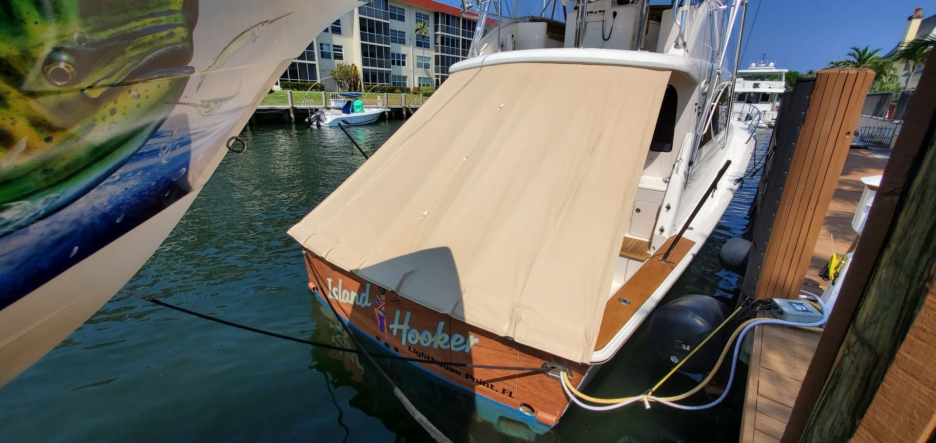 A boat is docked at a dock with a tarp on it.
