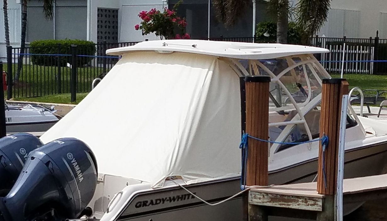 A boat is docked in front of a building with balconies