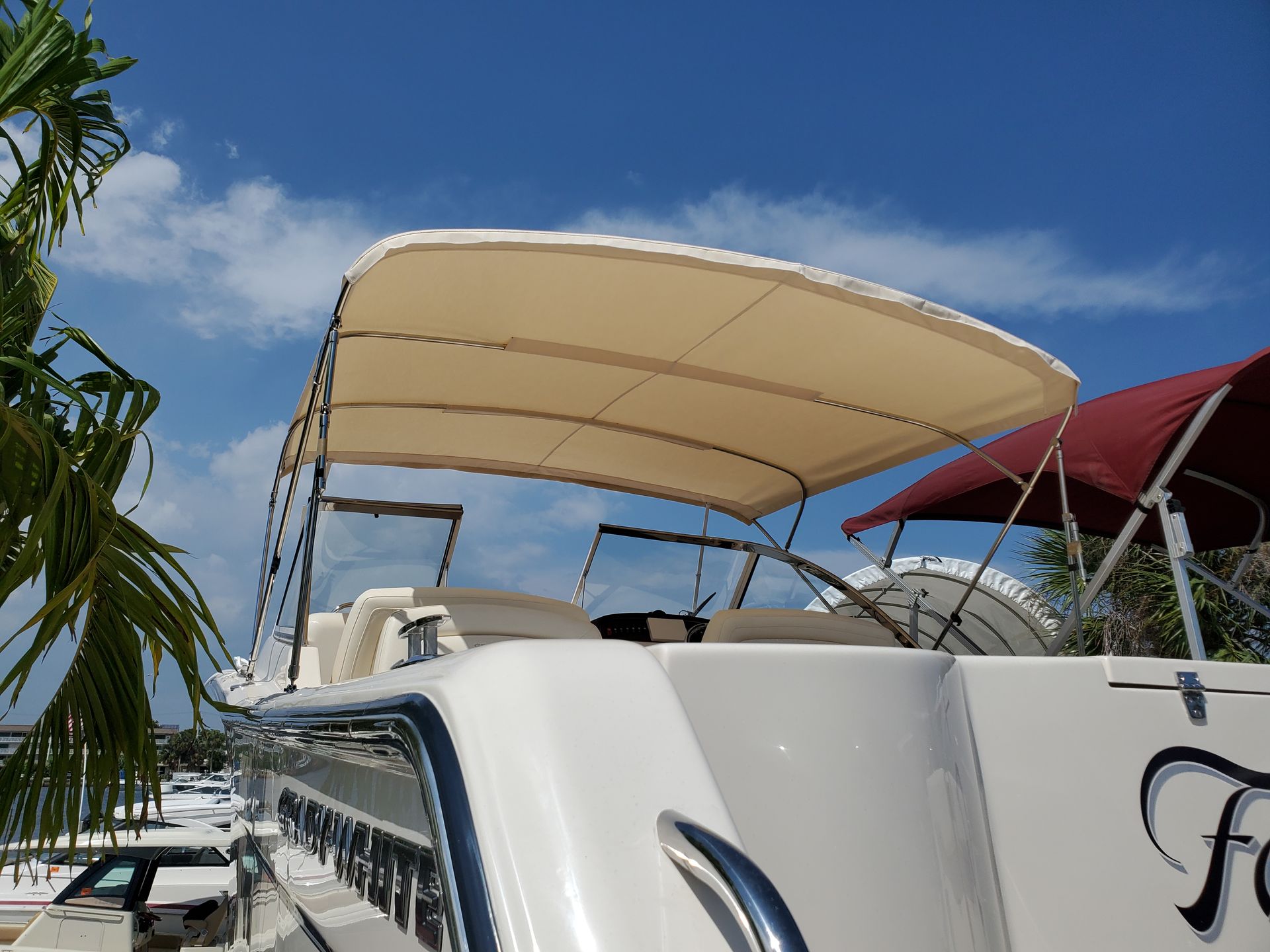 A white boat with a canopy on top of it