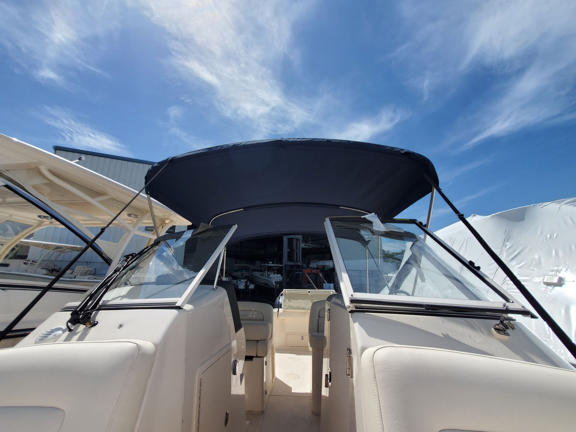 The front of a boat with a canopy on top of it.