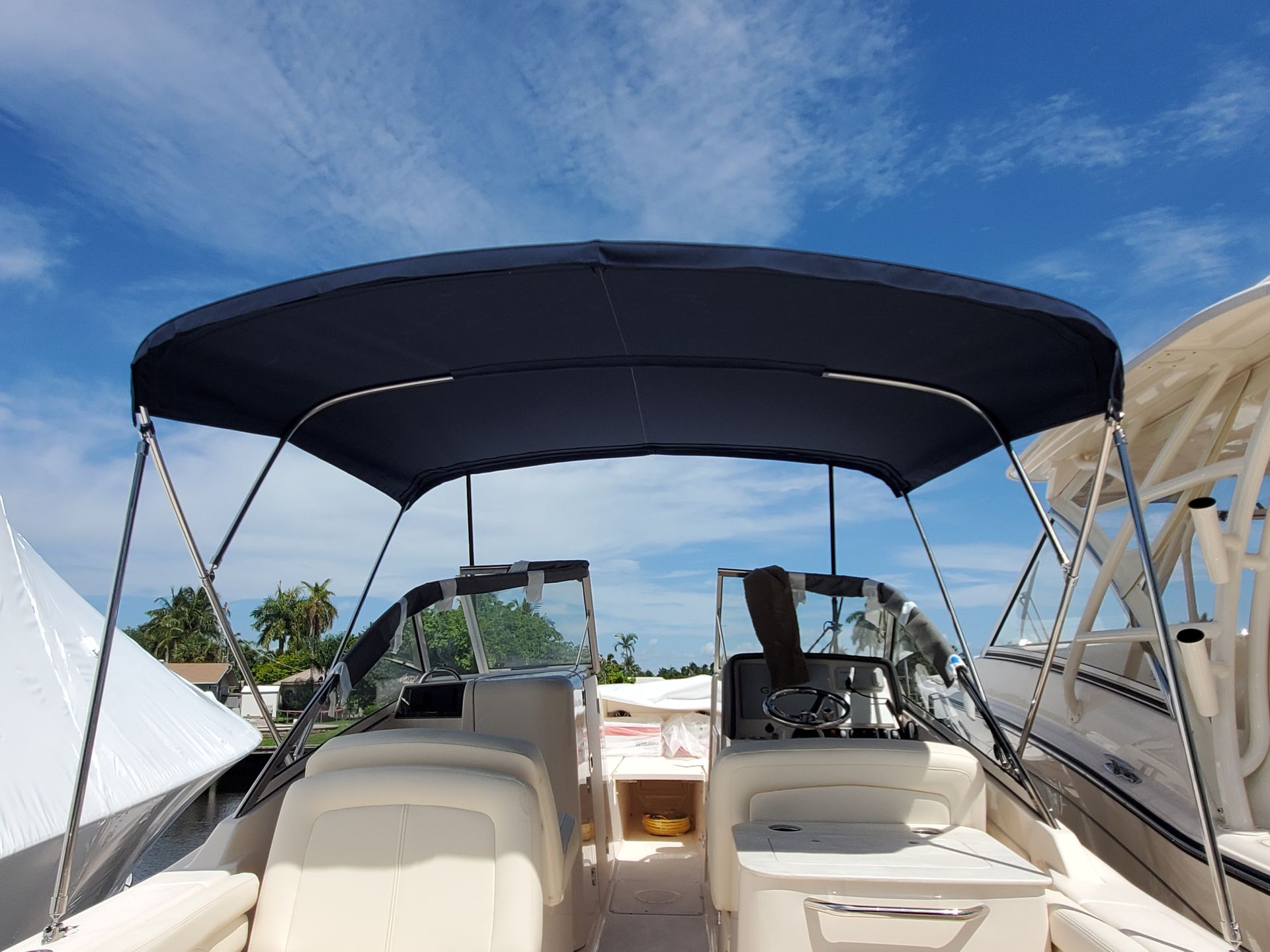 A boat with a blue canopy on top of it