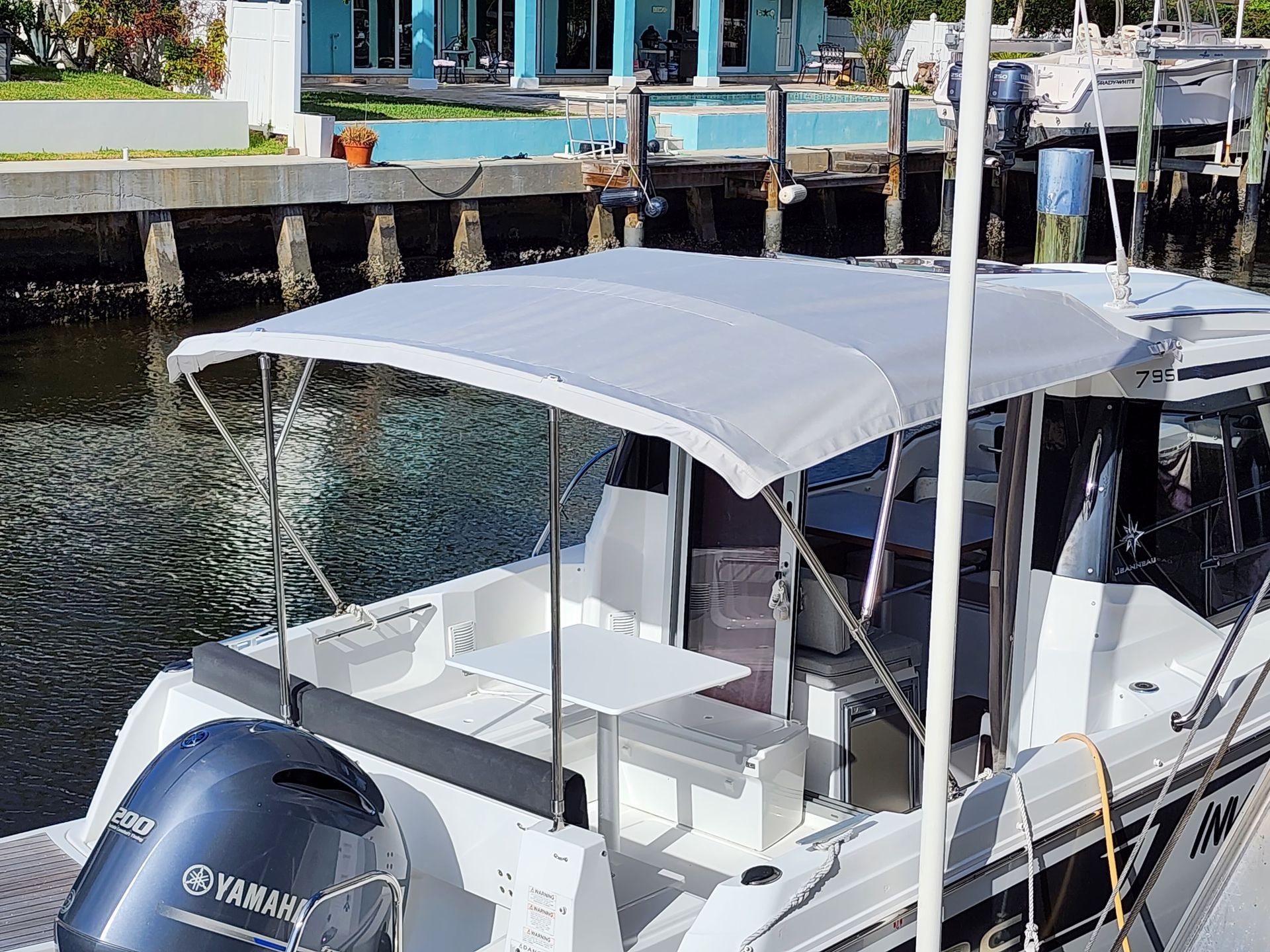 A boat with a yamaha engine is docked at a dock.