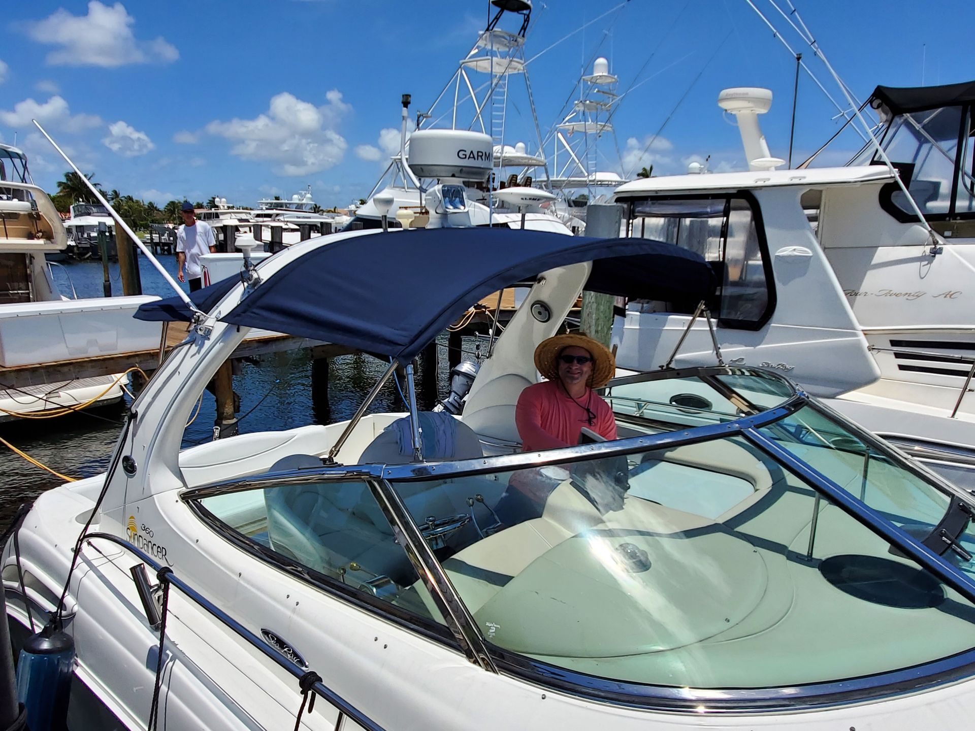 A woman in a red shirt is sitting on a white boat