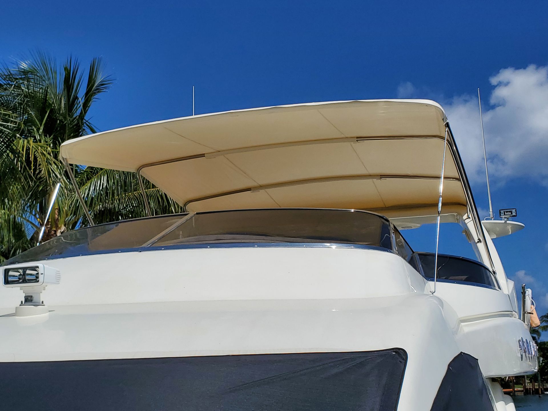 A white boat with a canopy on top of it