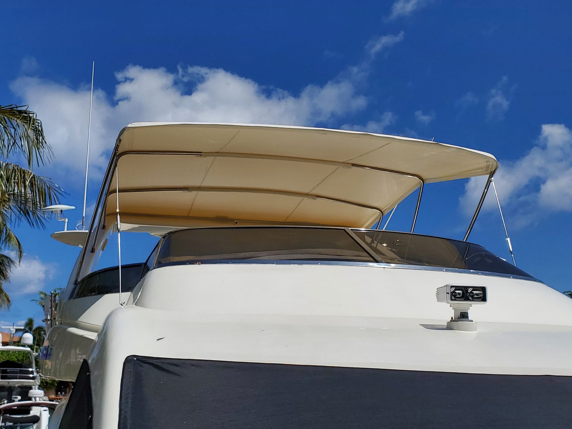 A white boat with a canopy on top of it