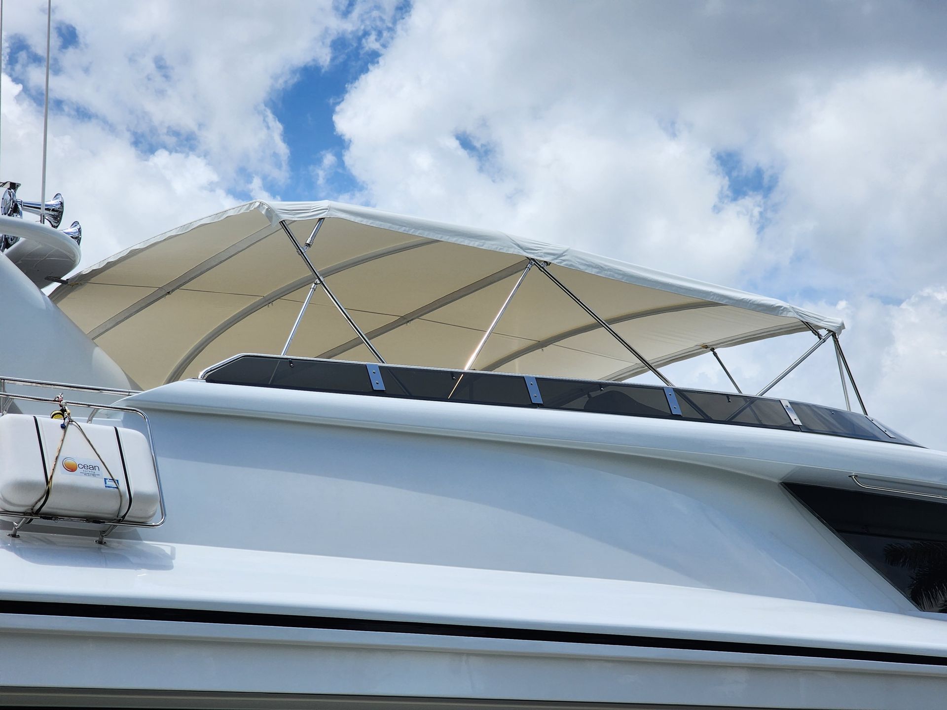 A white boat with a canopy on the top of it.