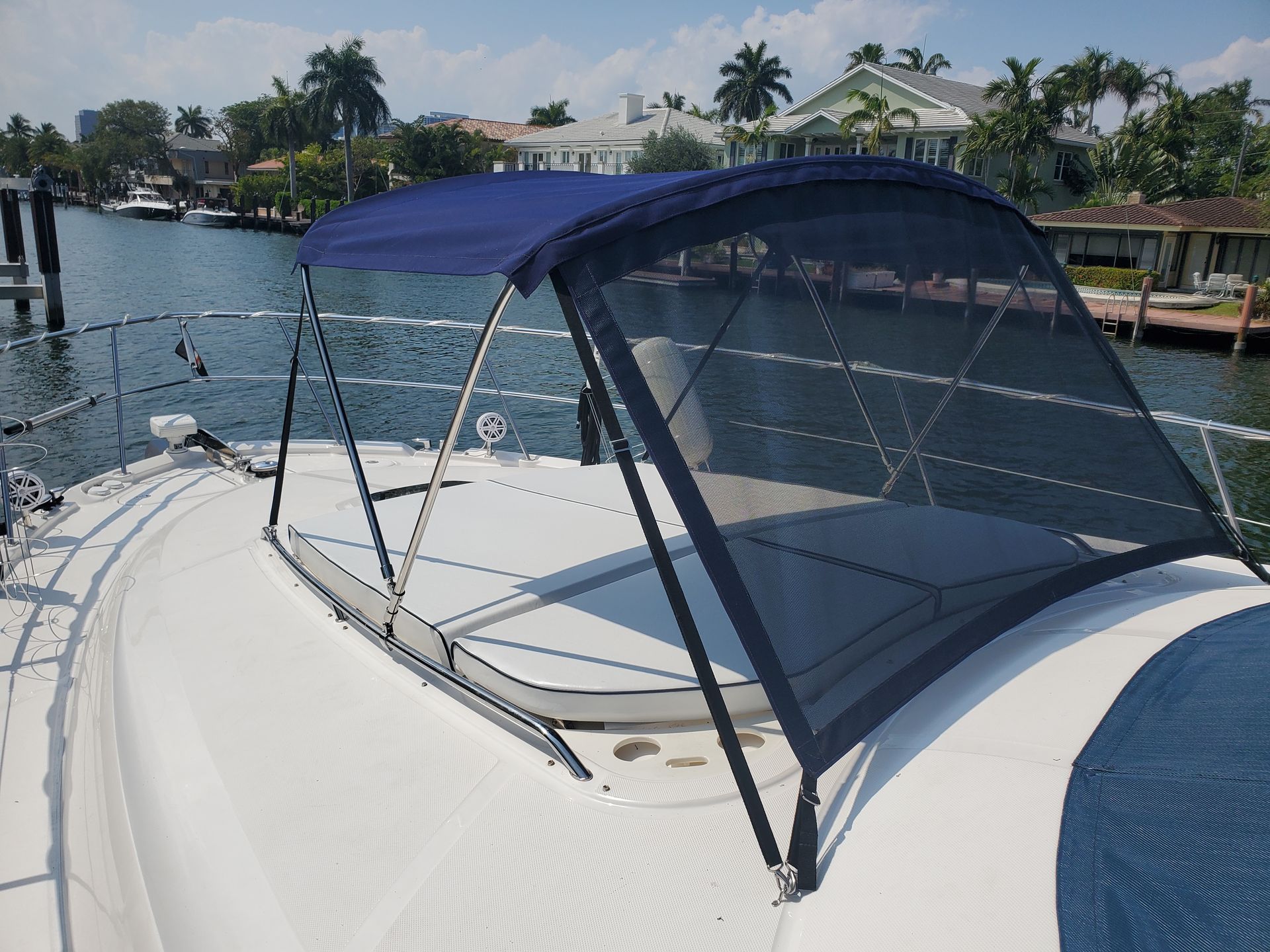 A boat with a blue canopy on top of it