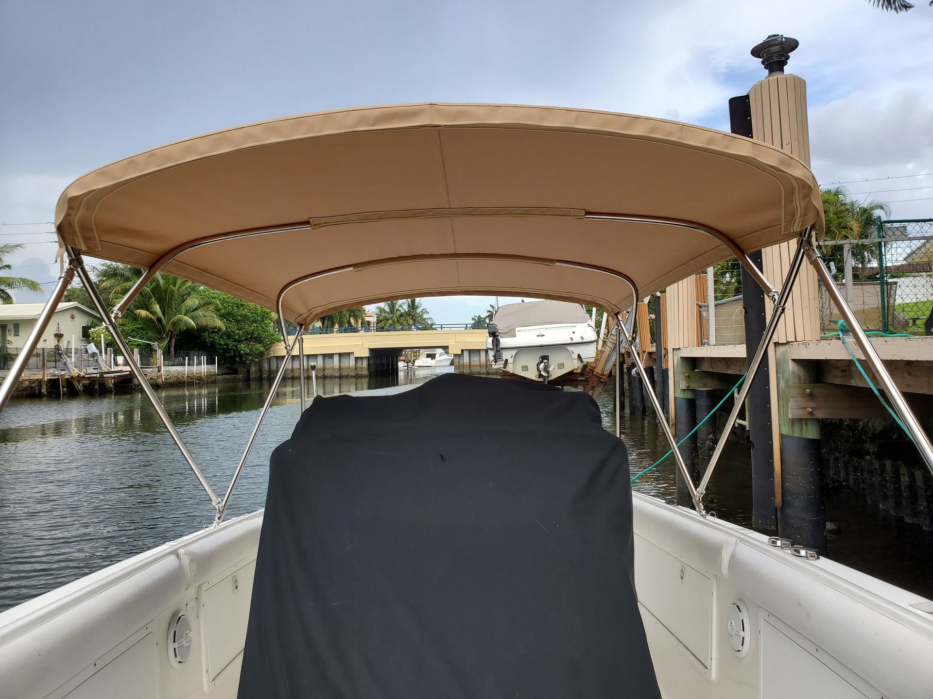 A boat with a canopy and a black cover on it