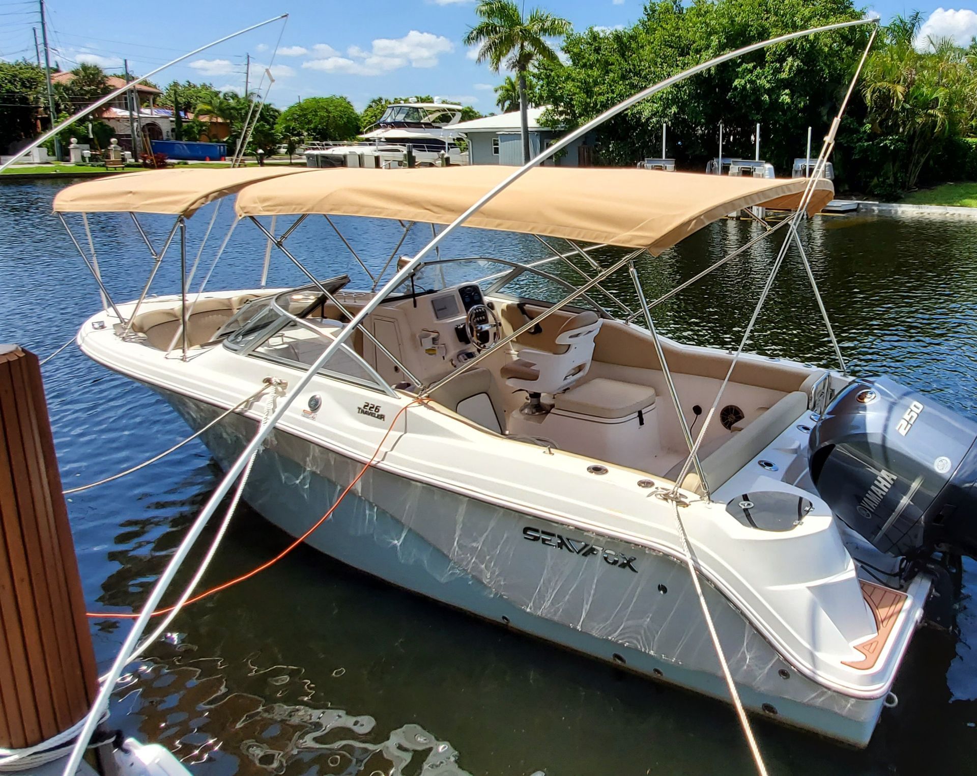 A boat with a canopy is docked in the water