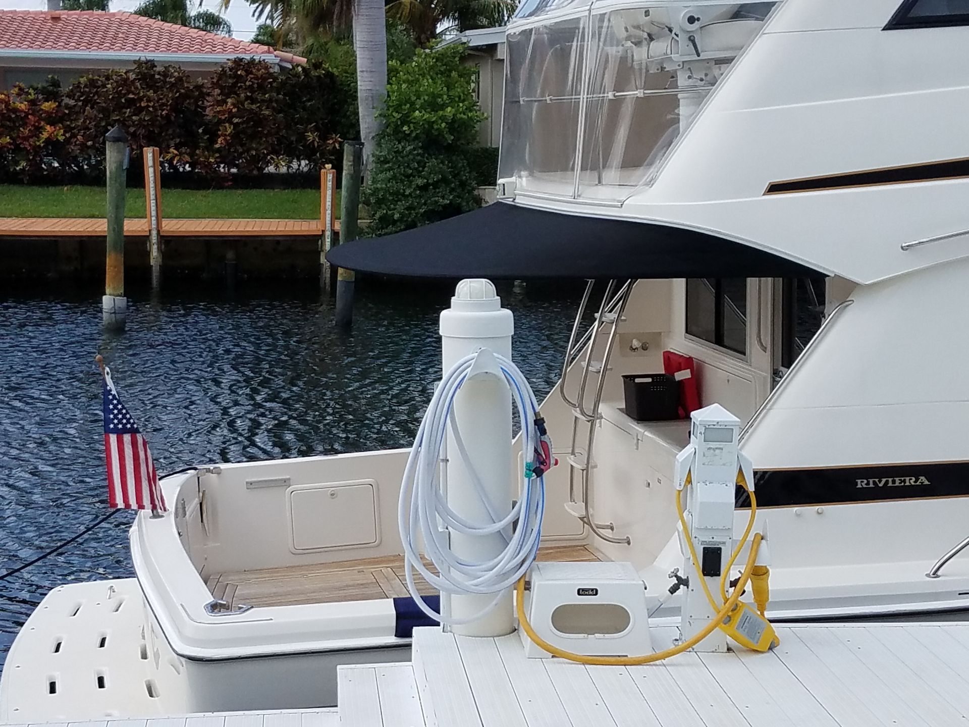 A boat is docked on a dock next to a house.