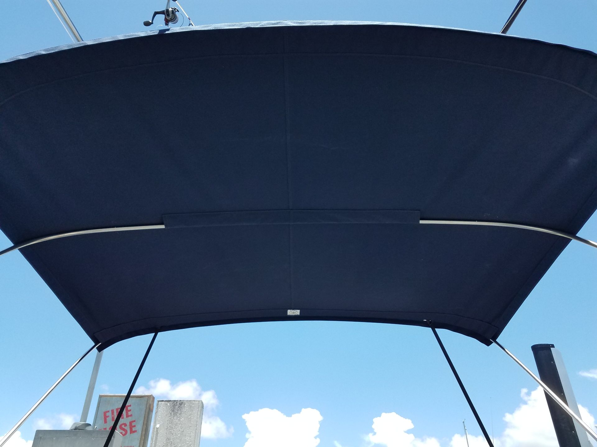 A blue canopy on a boat against a blue sky