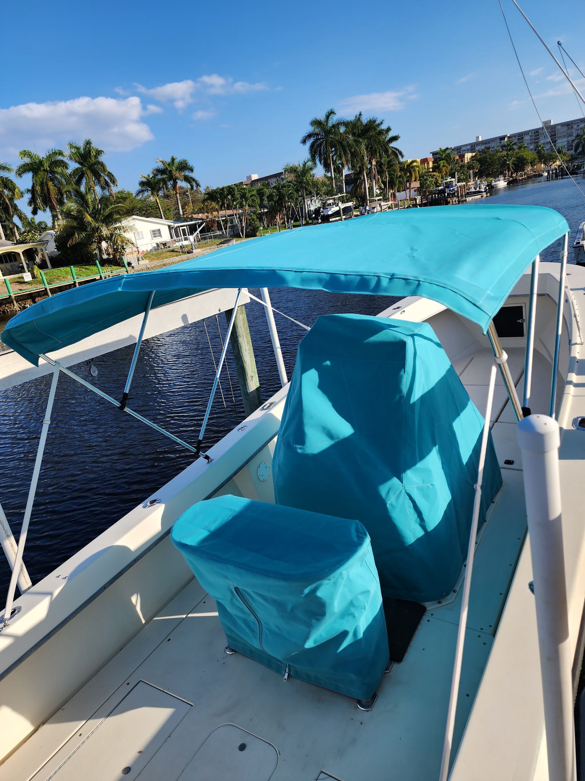 A boat with a blue canopy on top of it