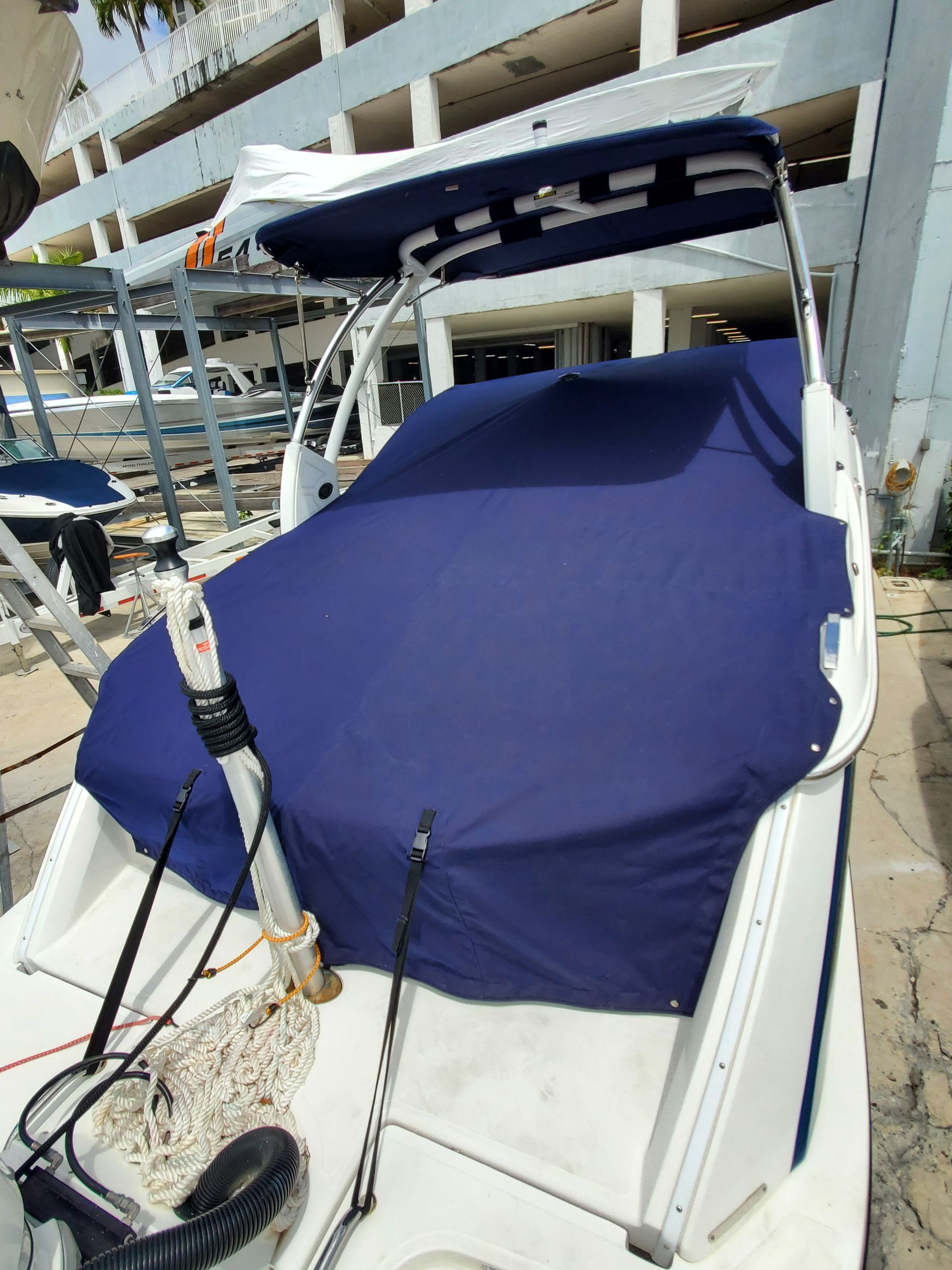 A boat with a blue cover on the top of it