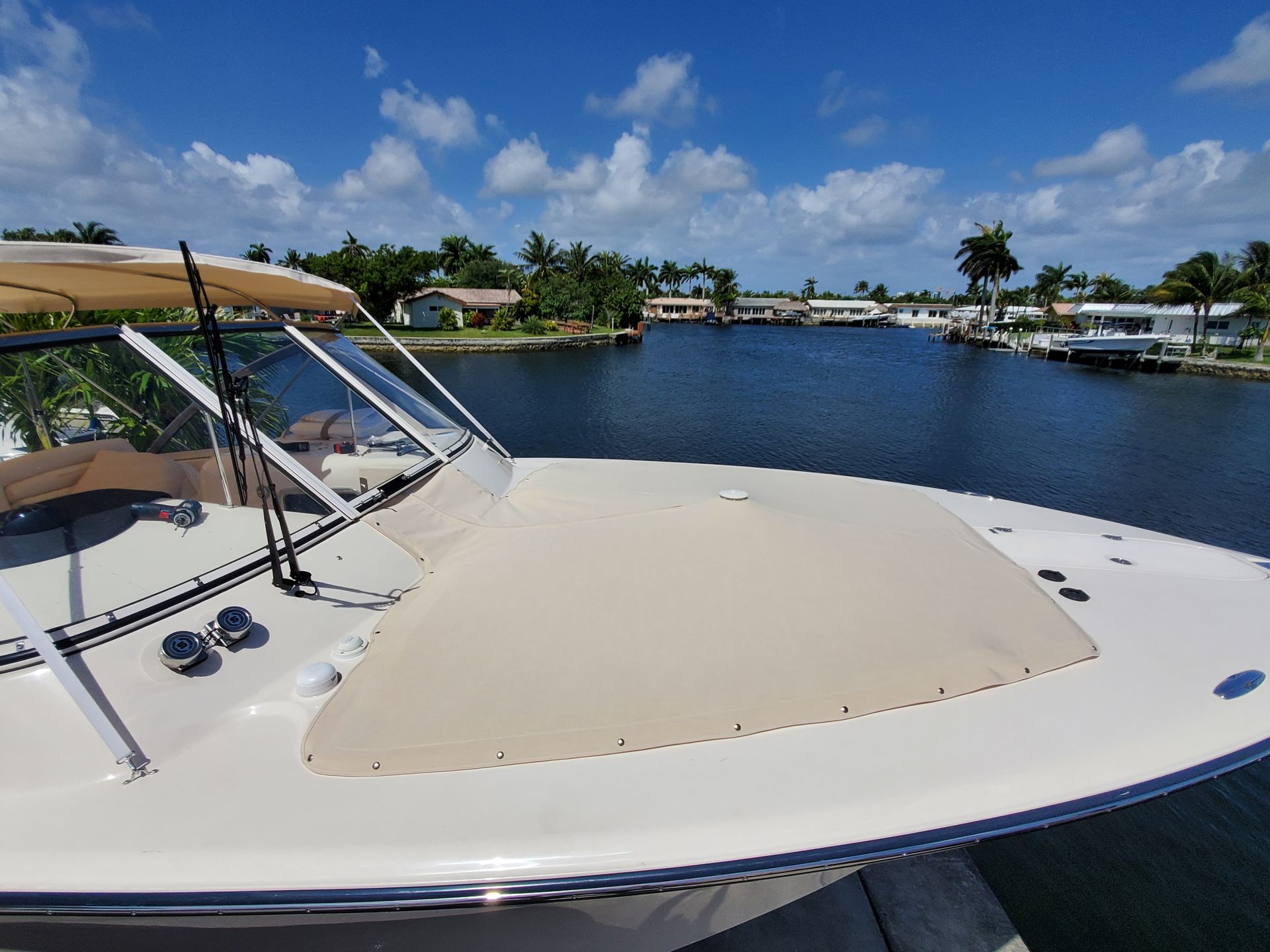 The front of a boat is sitting on top of a body of water.
