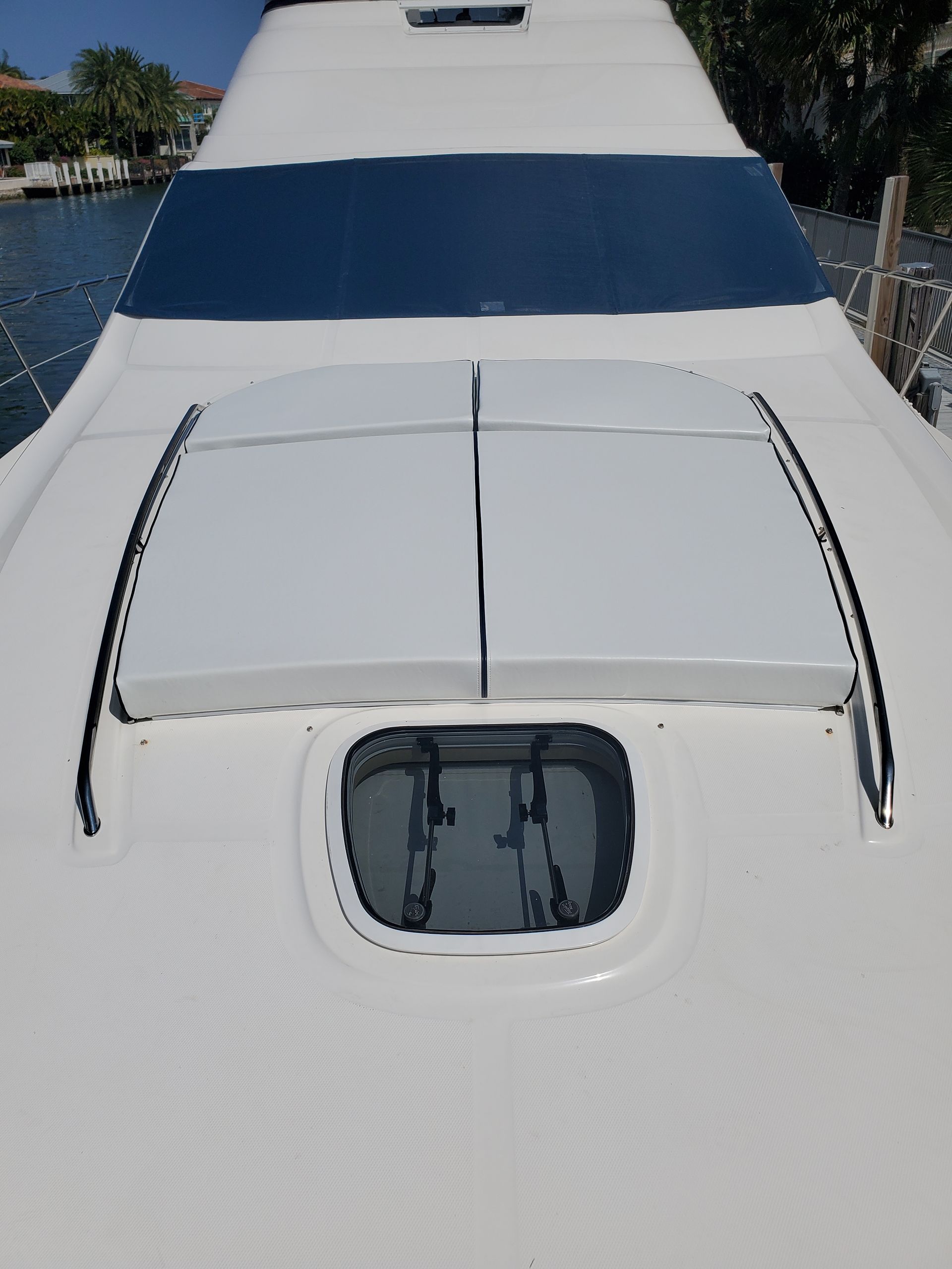 The front of a white boat with a large window