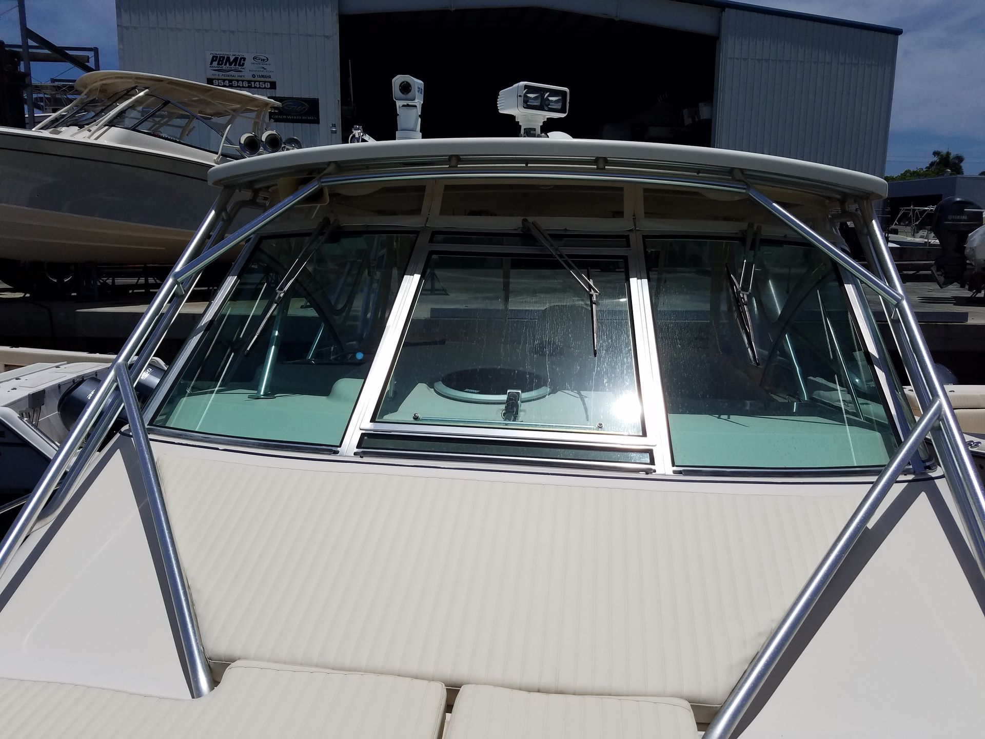 The front of a boat with a large windshield