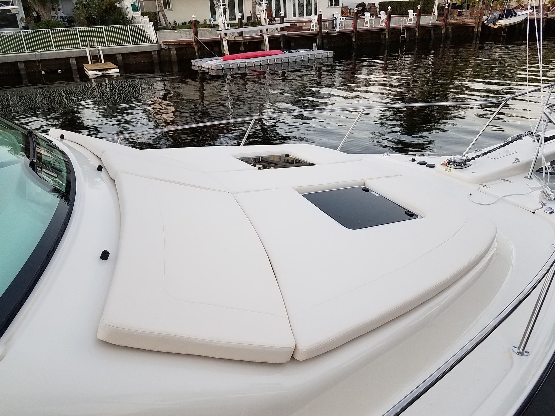 A boat with a cushion on the back of it is in the water