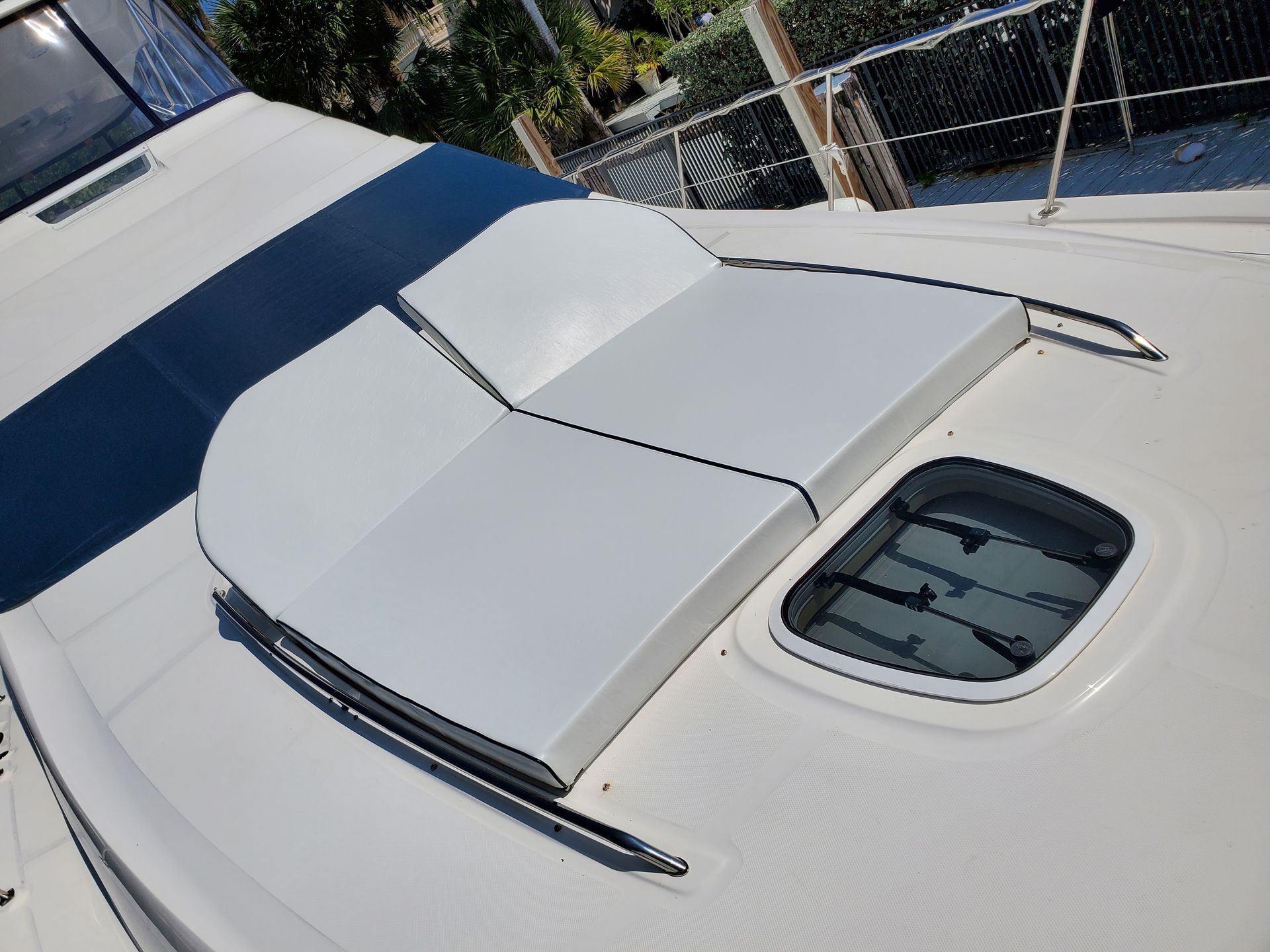 A white boat with a blue stripe on the side