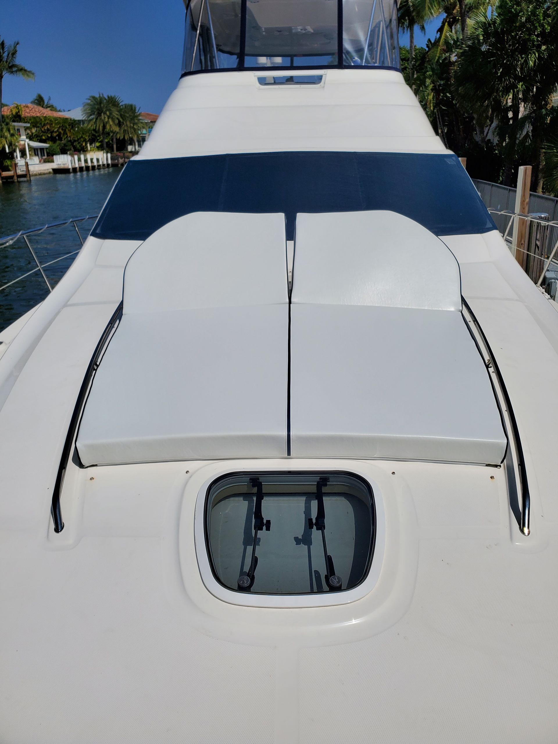 The back of a white boat with a window on it