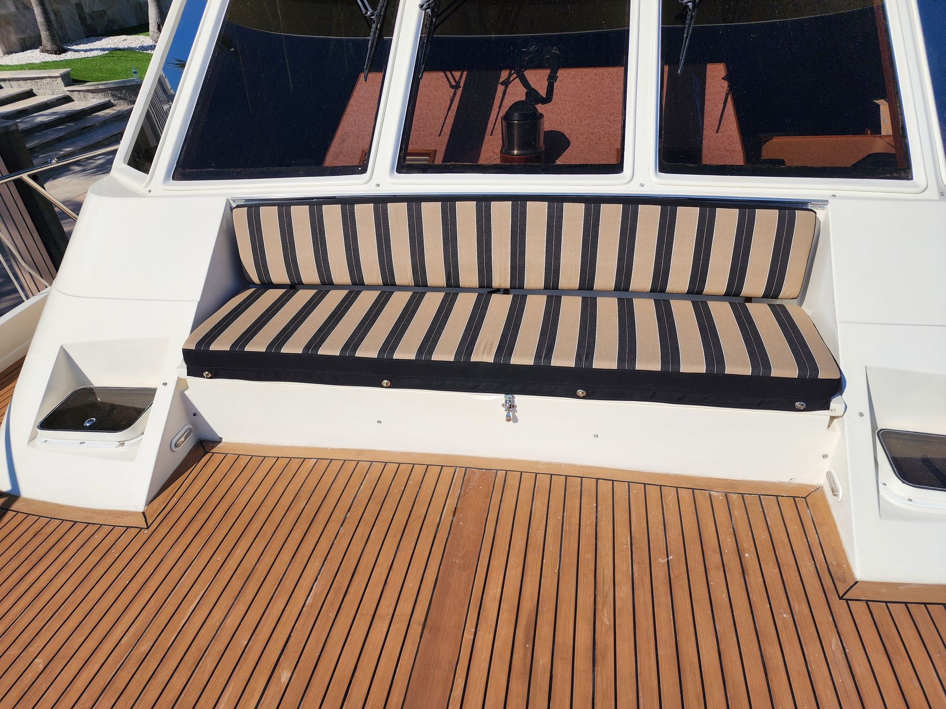 A boat with a striped cushion on the deck