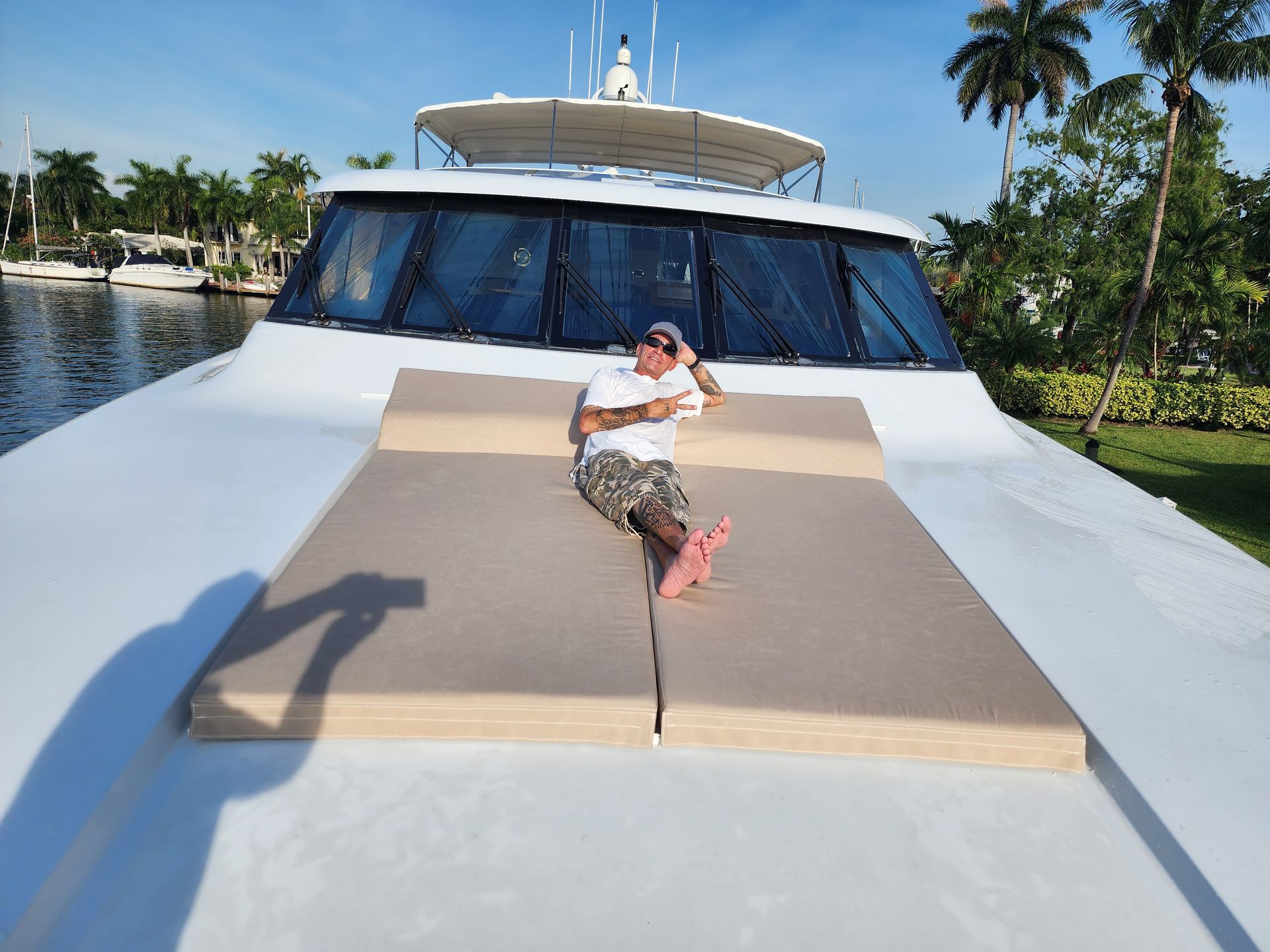 A man is laying on the back of a boat