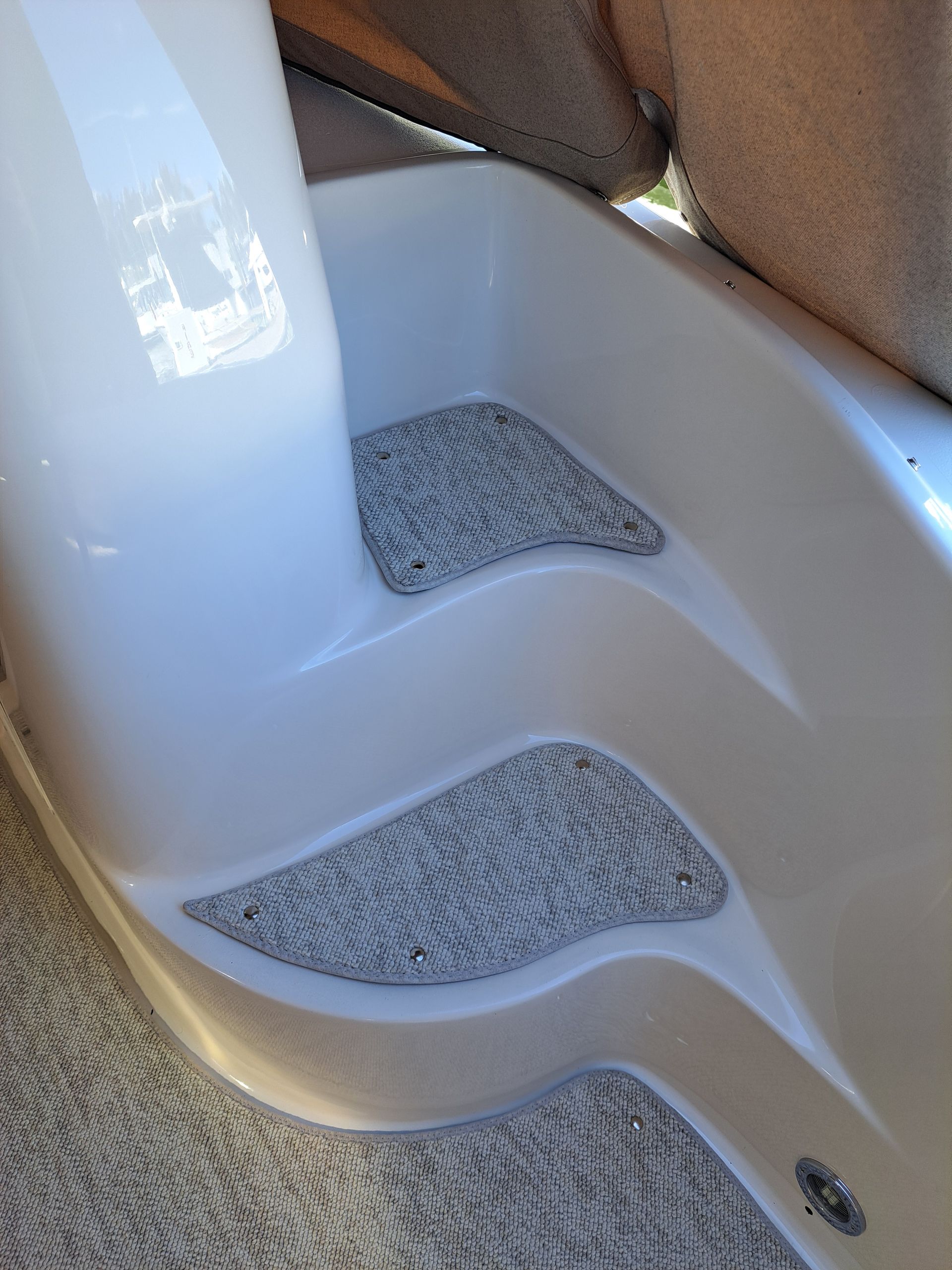 A close up of a white staircase with a carpeted floor