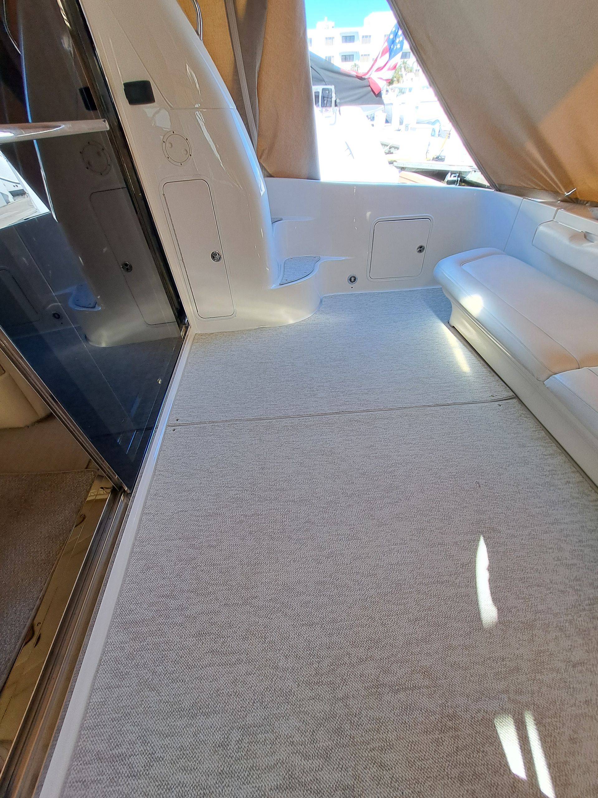 A white carpeted floor in a room with a window