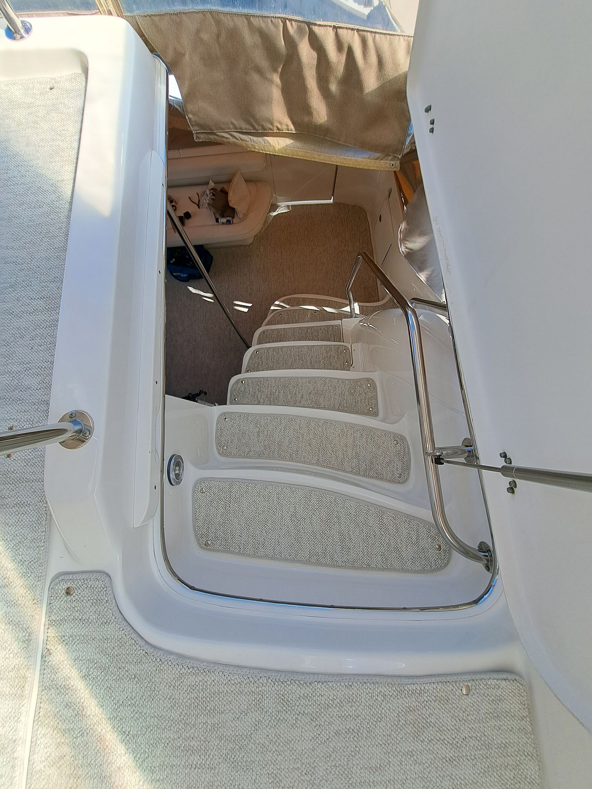 A boat with stairs leading up to the deck.