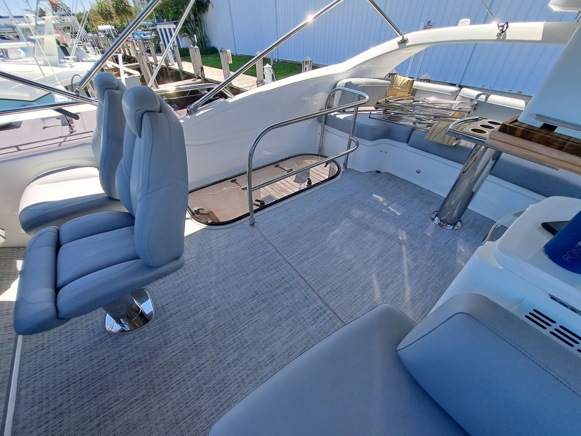 A boat with two chairs and a table on the deck