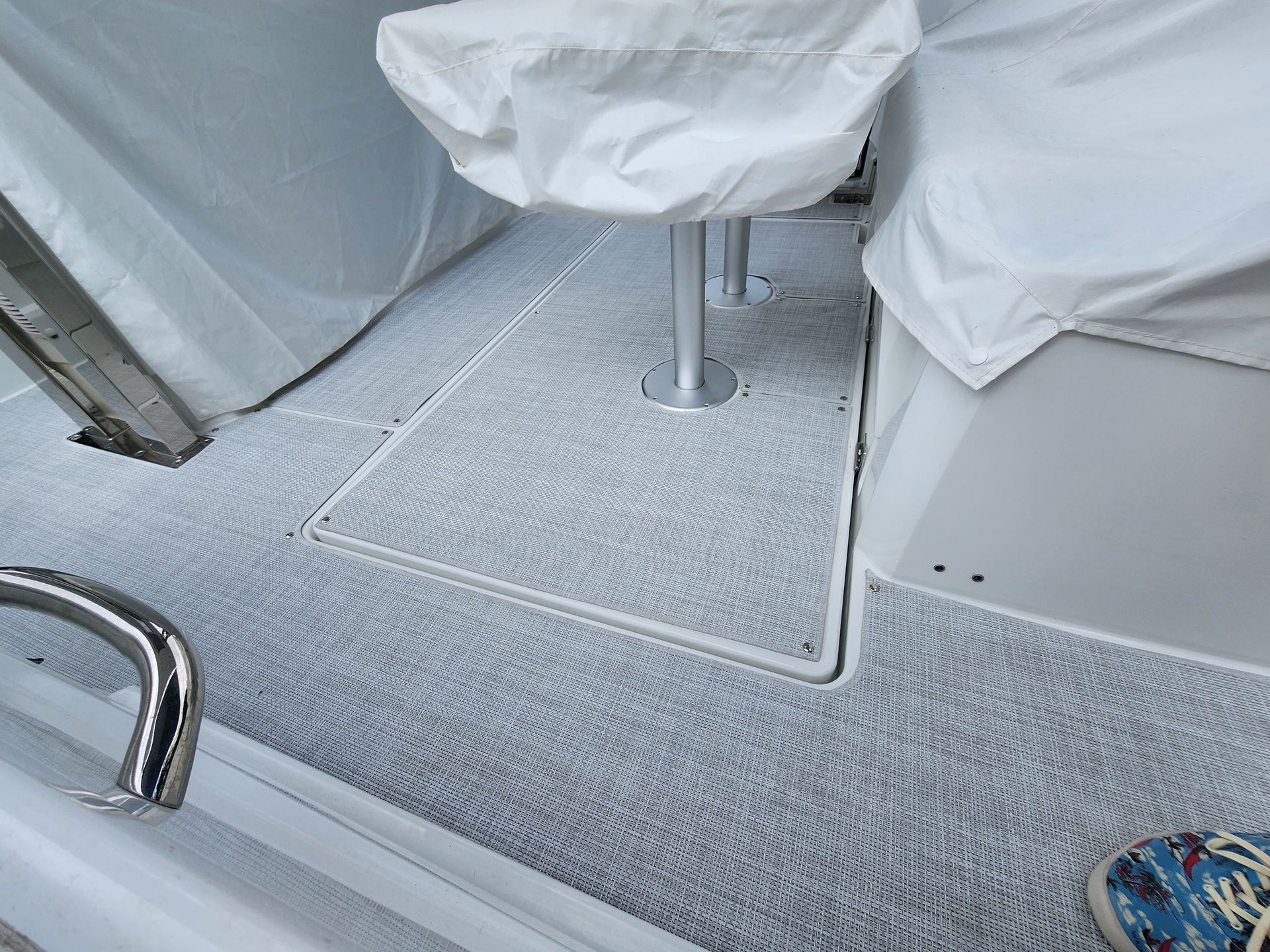 A person is standing on the deck of a boat.