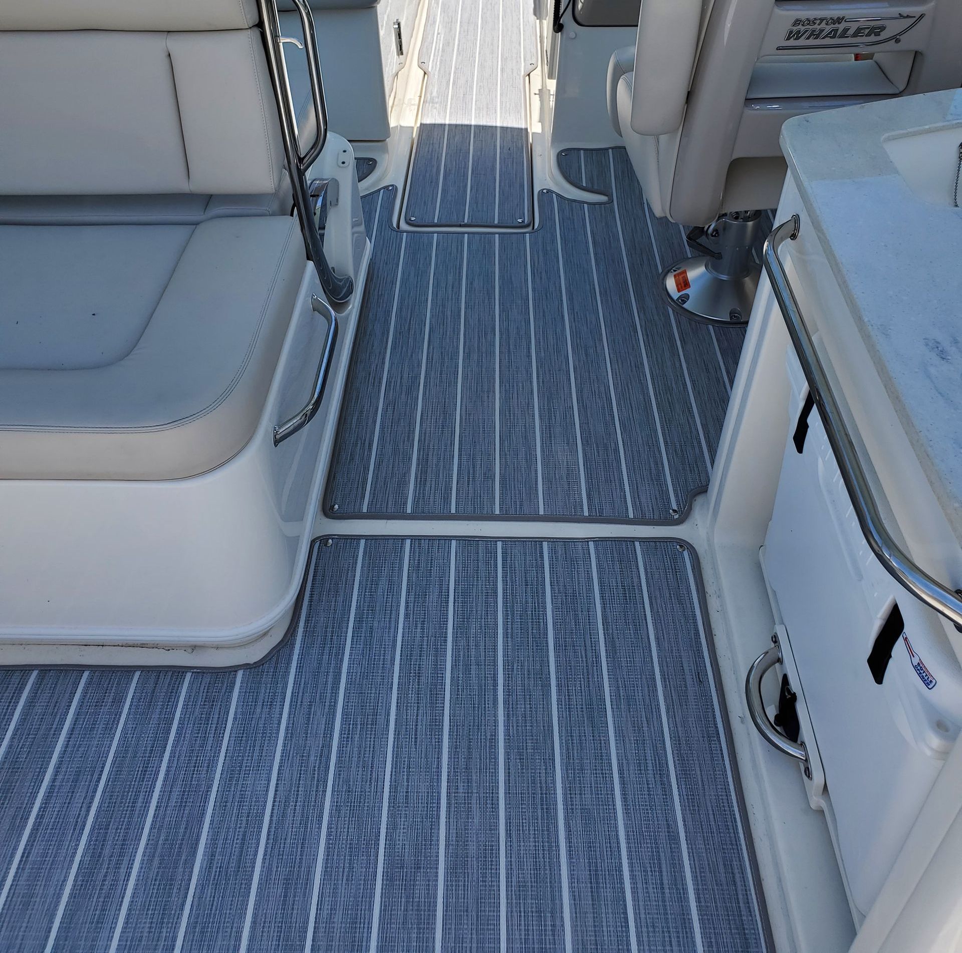 A white boat with a clear windshield and a blue trim