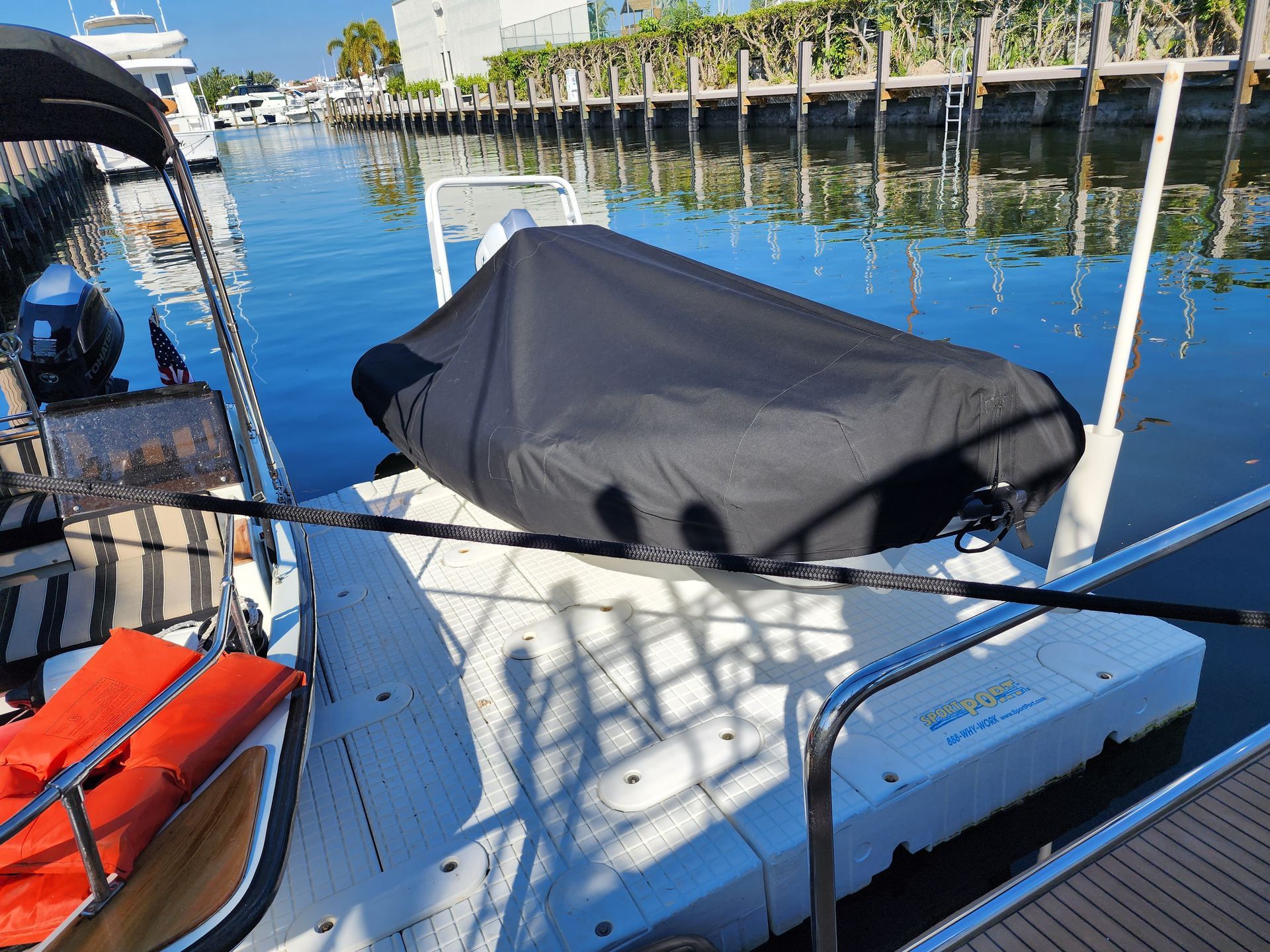 A boat with a black cover on the back of it